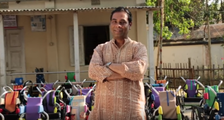 Dr Mohammed Muhit standing outside a community education centre