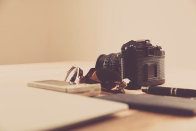 A camera and notebook on a desk representing digital media skills