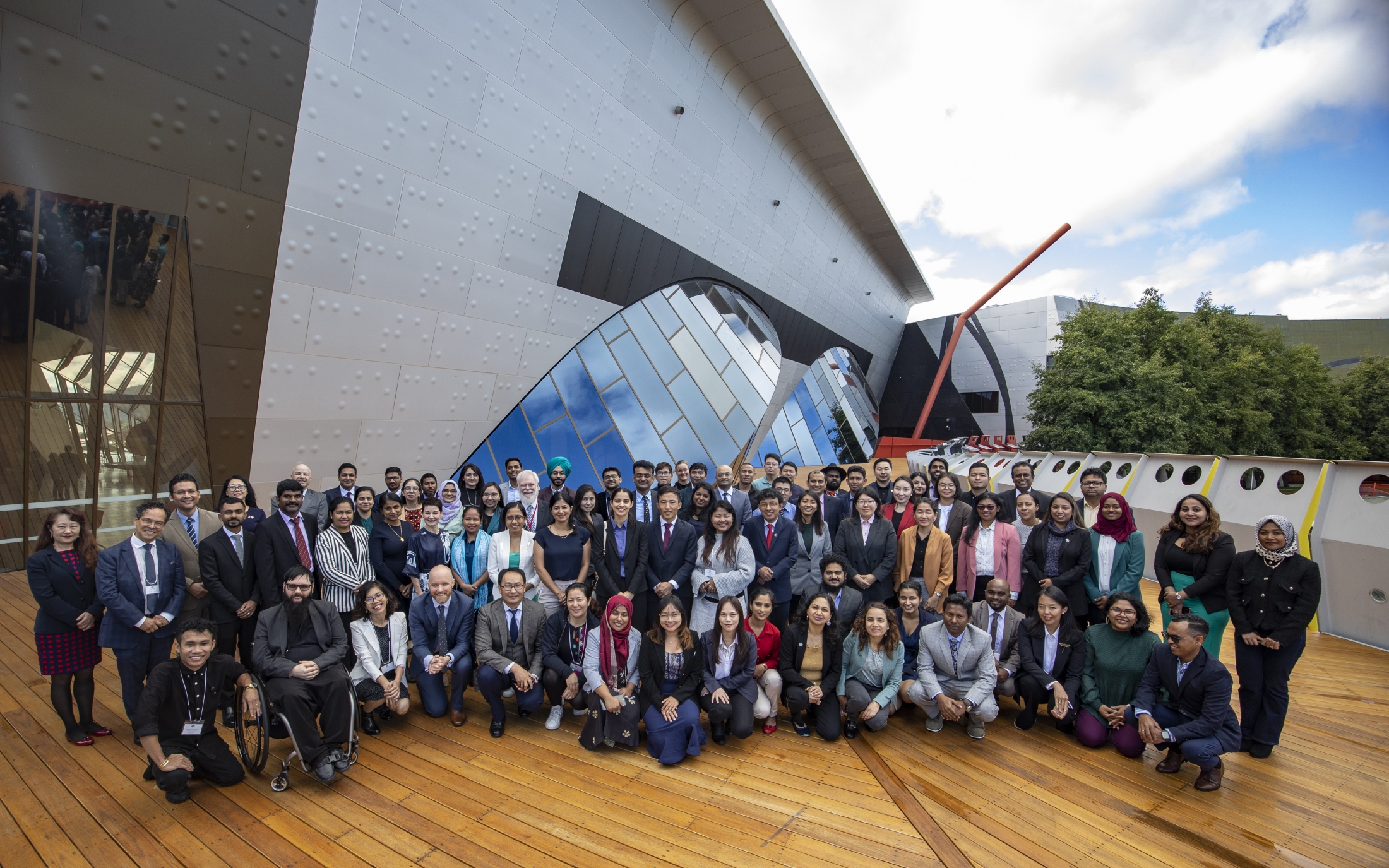 Scholars and officials pose at the opening of the workshop component of the Scholars Forum at the National Museum of Australia. 