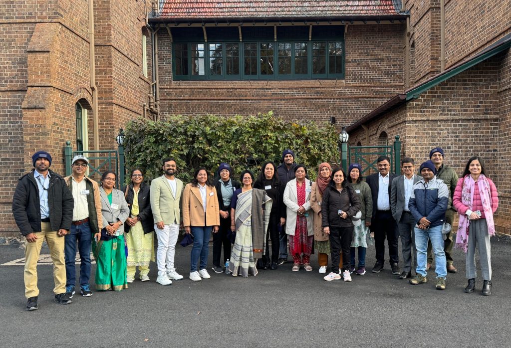 Participants standing in front of the University of New England.