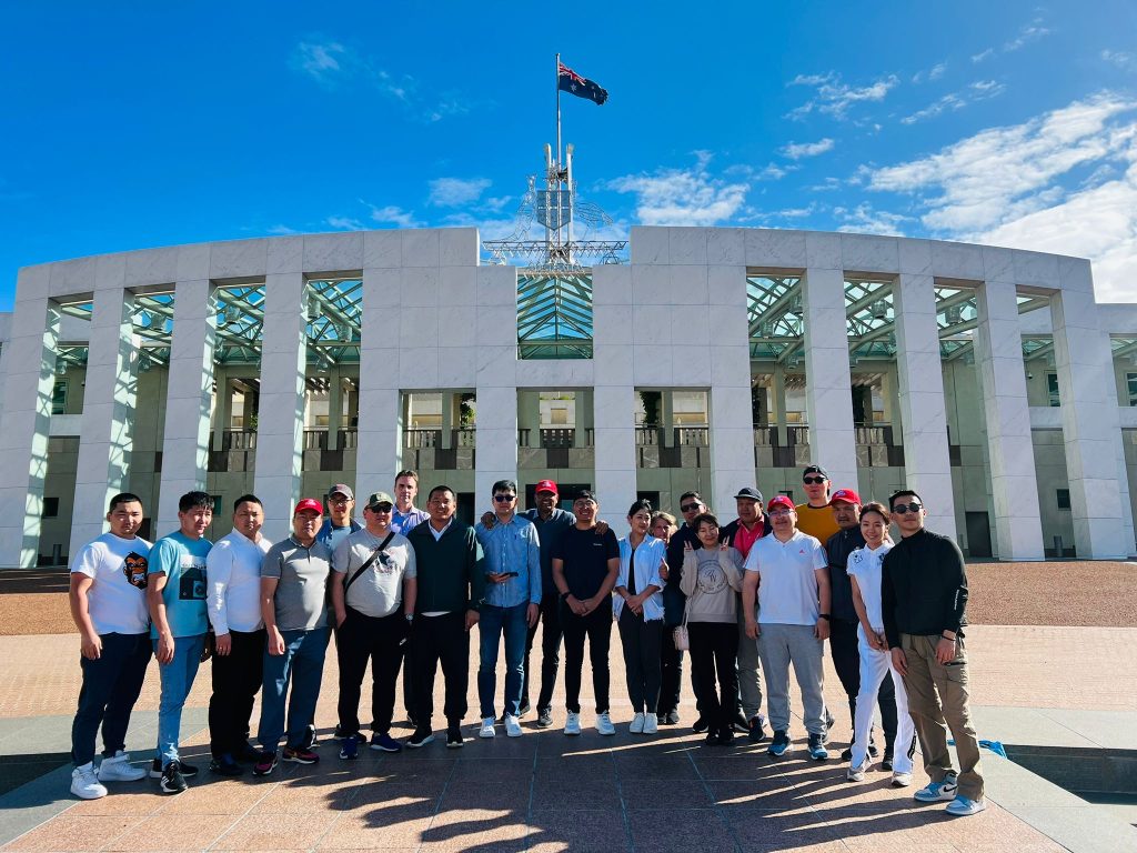 Ireedui (fourth from right) photographed with other Short Course participants in front of the Parliament House in Canberra.