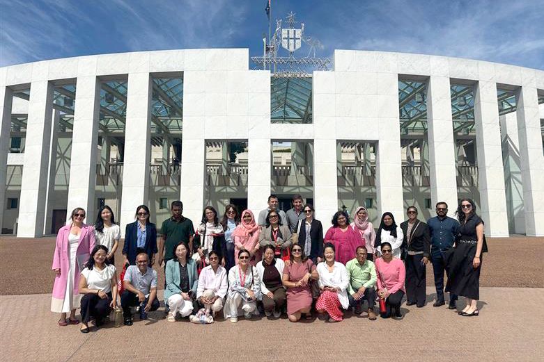Participants photographed in front of the Parliament House in Canberra.