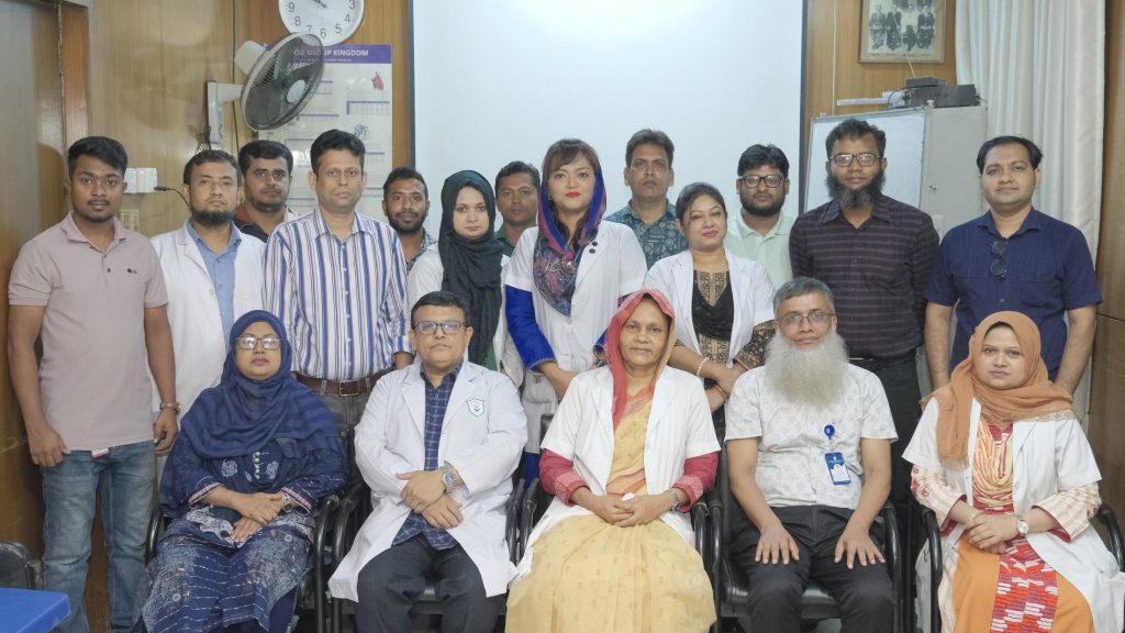 Farah (middle, standing) featured with her medical unit team at the hospital.