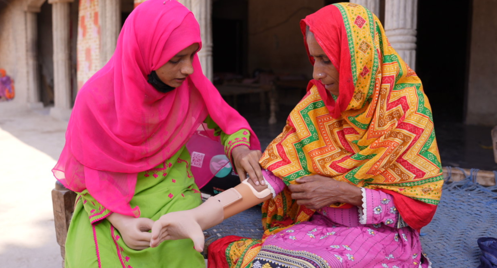Beyond technology: A peer mentor fitting a prosthetic alongside a new beneficiary