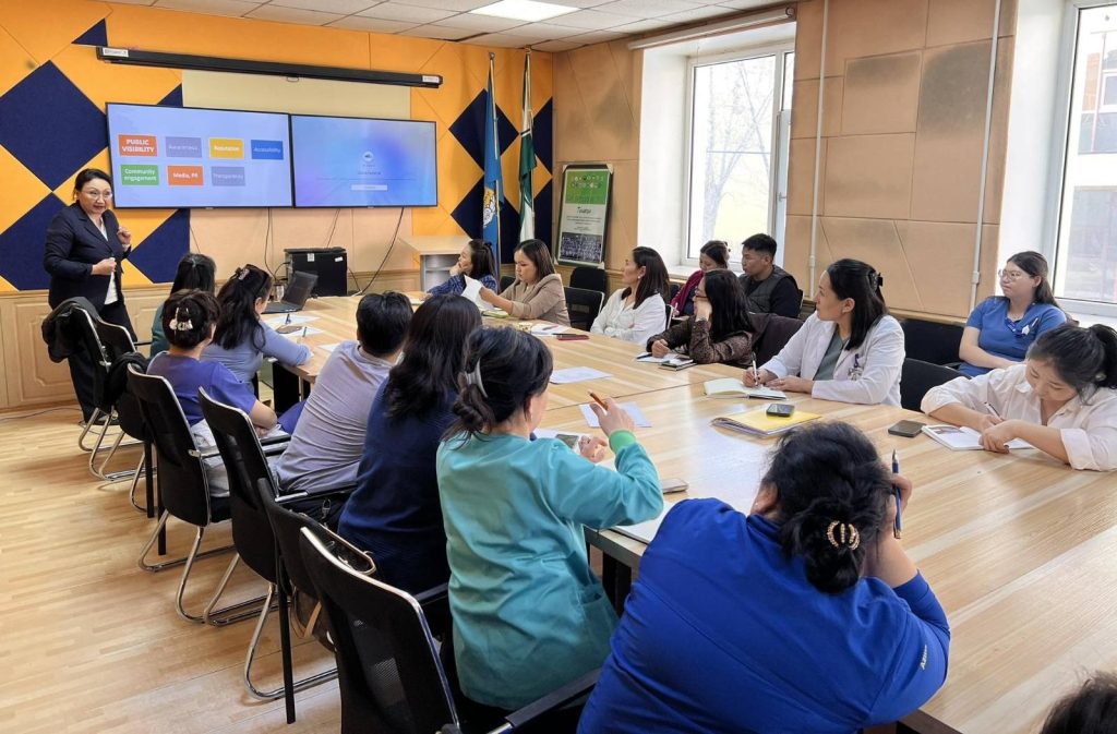 Dr Dagvadorj (left, standing) conducting a consultation session for district hospital staff as part of the project funded by the Asian Development Bank in Ulaanbaatar, Mongolia.