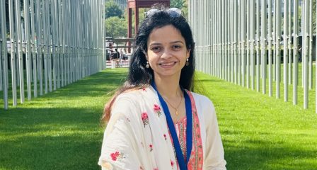 Portrait of Aditi Pathak among international flags