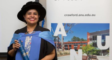Dr Nazneen Kawshar Chowdhury in graduation gown holding her diploma