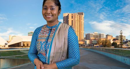 Sameya Karim standing by the Adelaide city skyline