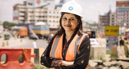 Asfia Sultana wearing a hard hat and safety vest at a construction site