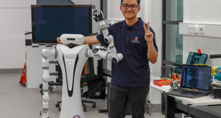 Scholar standing beside a humanoid robot in a laboratory