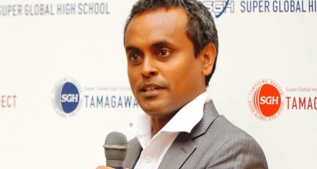 Dr Ibrahim Zuhuree speaks into a microphone at an event