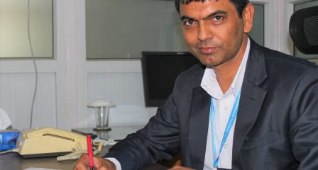 Australia Awards alumnus Prakash Dahal working at his desk