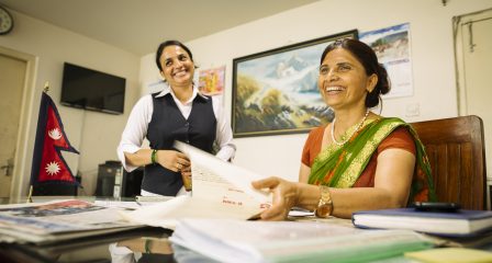 Australia Awards alumna Indu Ghimire meeting colleagues in her office